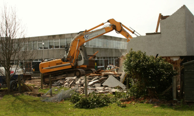 The contractor taking down the janitors house at Warddykes school in Arbroath.