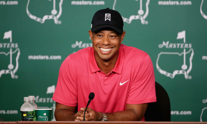 Tiger Woods jokes with the press yesterday as he prepares to make his comeback at Augusta.