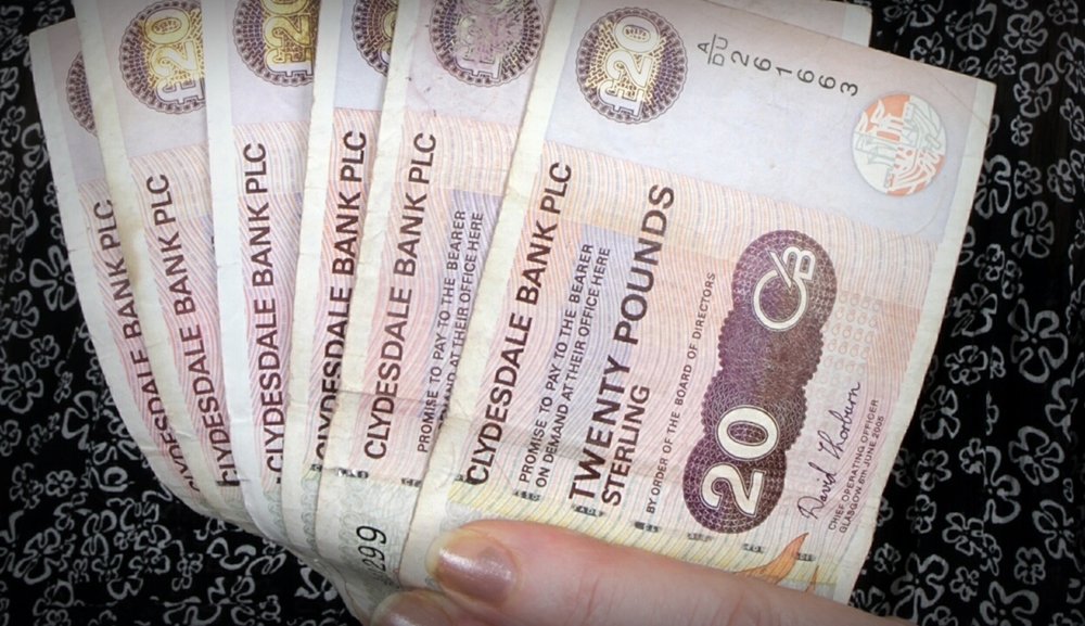 Susan Morton promotes Evening Telegraph competition - woman holding money, cash, banknotes.
