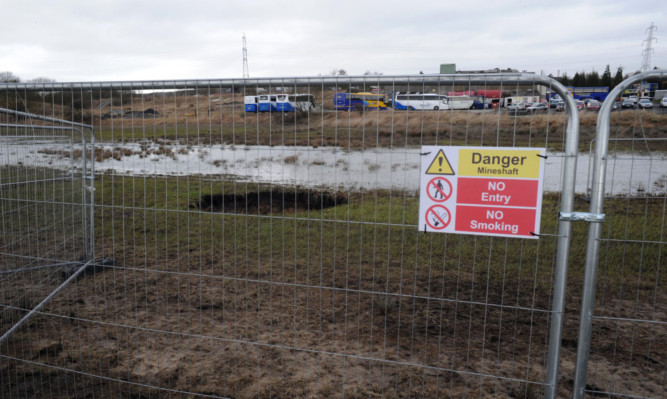 The sinkhole which appeared on the site a year ago.