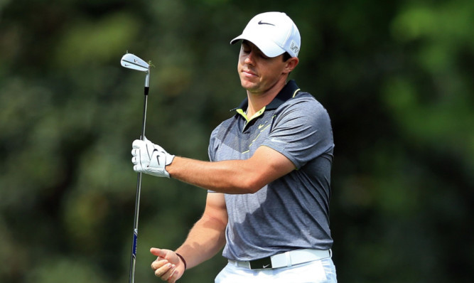 Rory McIlroy cannot watch after an errant approach shot at the fifth hole.