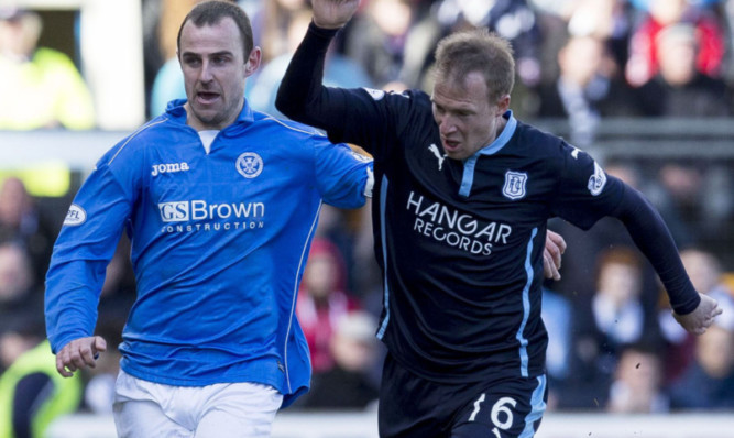 Dave Mackay battles for the ball with David Clarkson.