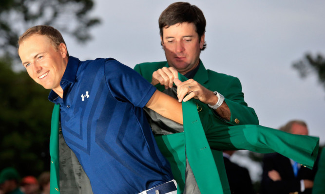 Former champion Bubba Watson presents Jordan Spieth with the green jacket.