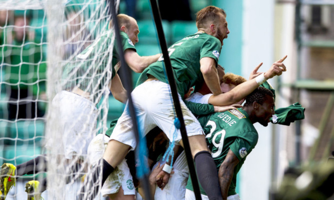 Hibs players mob Farid El Alagui after he scores his side's second goal of the game.