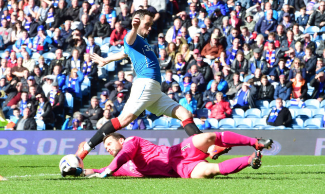 Rangers' Nicky Clark (above) challenges Kevin Cuthbert.