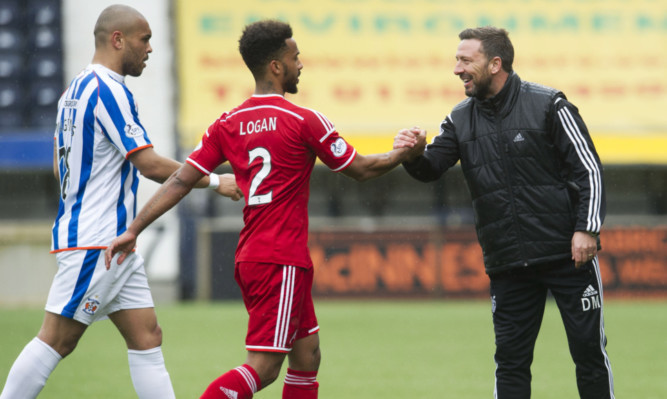 Aberdeen manager Derek McInnes  shakes hands with Shay Logan at full-time.