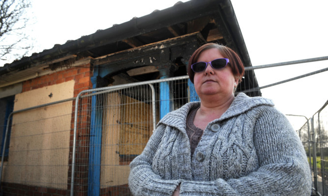 Irene Shearer, chairwoman of the Friends of Baxter Park, beside the fire-damaged pavilion.