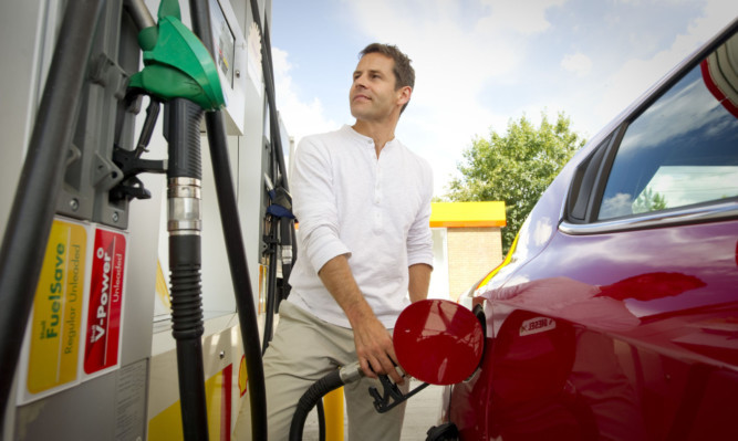 A motorist fills up at the pumps.