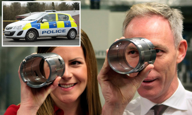 Jim Murphy and Labour candidate Melanie Ward at Fife Fabrications while (inset) police waited outside.