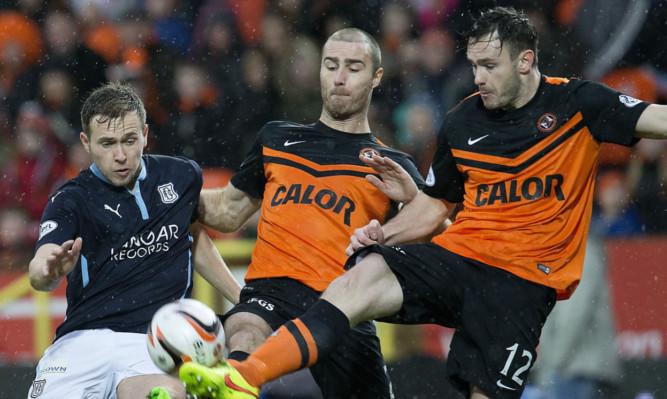 Dundee's Greg Stewart did battle with Sean Dillon (centre) in a previous Dundee derby this season.