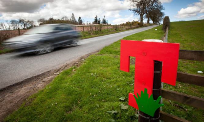 A wooden sign showing support for the festival on the Tullibardine to Muthill Road by Auchterarder.