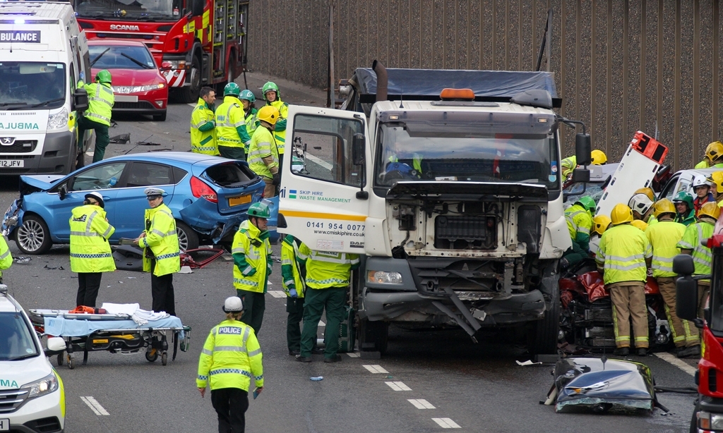 The emergency services attend an eight vehicle crash on the M8 at Charing Cross in Glasgow. April 17 2015. The collision happened between J18 Charing Cross and J19, before the Kingston Bridge, at about 09:00 this morning. Police Scotland said at least two people were trapped in vehicles and emergency services were working to remove them and deal with casualties.