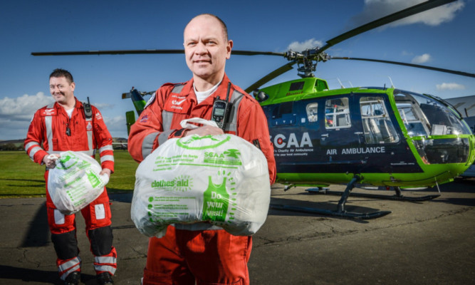 SCAA paramedics Craig McDonald, left, and John Salmond with a couple of Clothes Aid bags of unwanted garments.