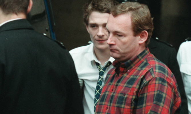 Andrew Drummond (in red shirt) is led away to serve his seven-year jail sentence for theft in 2002.