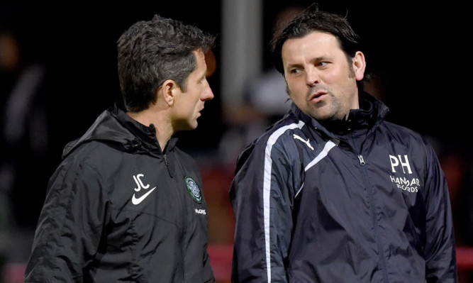 Dundee manager Paul Hartley (right) speaks with Celtic assistant John Collins at full-time.