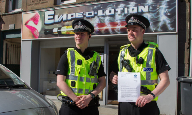 PCs Norman Sharp (left) and Mike Anderson of the Community Investigation Unit handed a letter to the legal high shop Evape-o-Lution in Montrose.