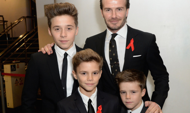 Brooklyn Beckham (left) with his dad and brothers.
