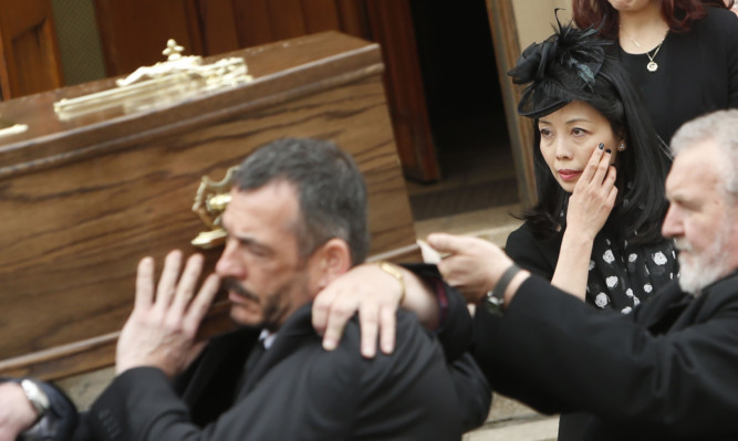 Shuming McCabe looks on as the coffin of former Labour MSP Tom McCabe is carried from St Marys Church in Hamilton.