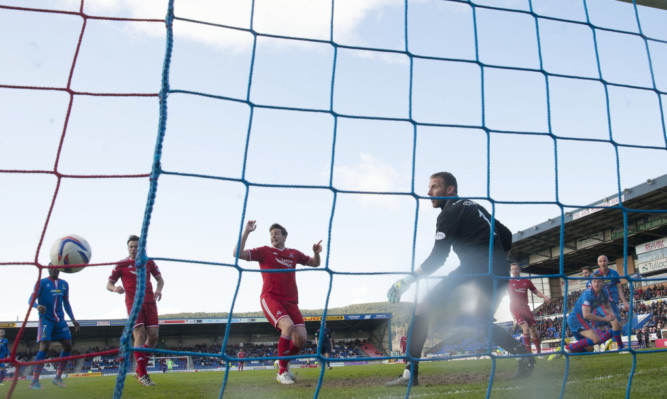 Aberdeen's Niall McGinn's free kick is deflected off ICT's David Raven (far right) and finds it's way into the back of the net.