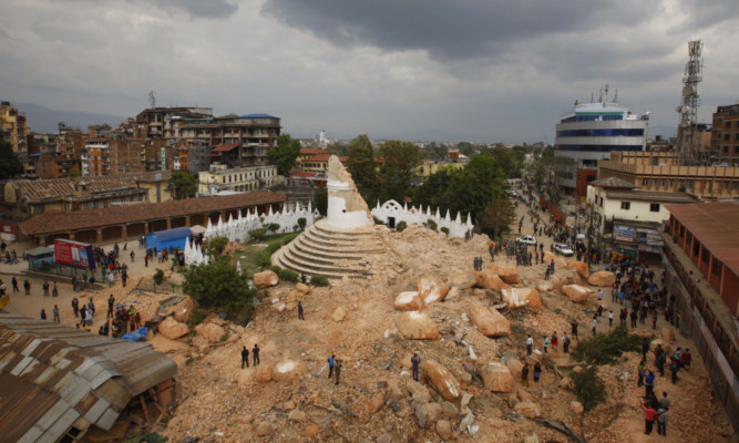 One of the Kathmandu 's landmark Bhimsen tower is seen in rubbles after it was damaged in Saturdayís earthquake, in Kathmandu, Nepal, Sunday, April 26, 2015. The earthquake centered outside Kathmandu, the capital, was the worst to hit the South Asian nation in over 80 years. It destroyed swaths of the oldest neighborhoods of Kathmandu, and was strong enough to be felt all across parts of India, Bangladesh, China's region of Tibet and Pakistan.