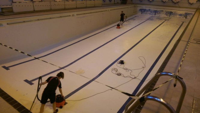 Staff cleaning the pool floor over the weekend.