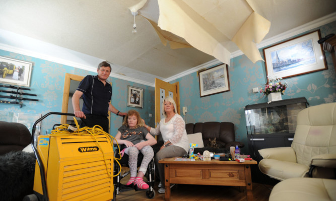 The McLarens say they are living in a condumned house after it was flooded.