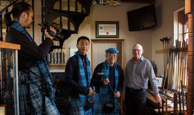 A tartaned China Golf Channel crew filming at Simpsons golf shop, from left: Wu Kexin, Zhang Clement and Li Wei Jian with Trevor Williamson, grandson of Robert Simpson.