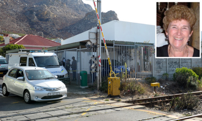 Family members attending the scene where Sandra Malcolm (inset) was found dead.