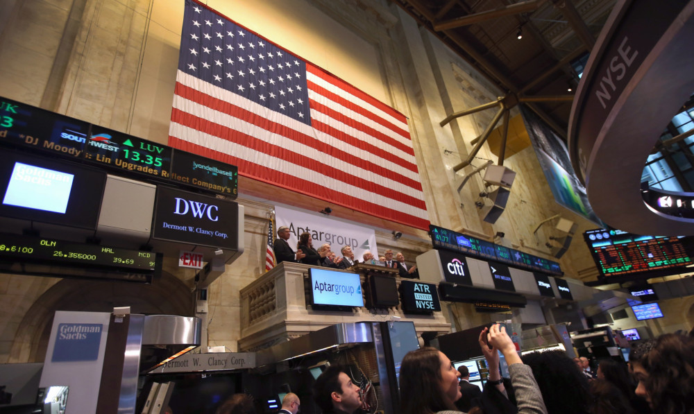 Visitors applaud at the closing bell of the New York Stock Exchange after the market recovered from the shock of the fake tweet.