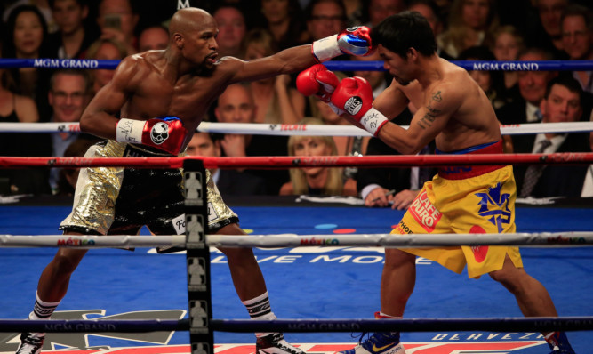 Floyd Mayweather Jr. throws a left at Manny Pacquiao.