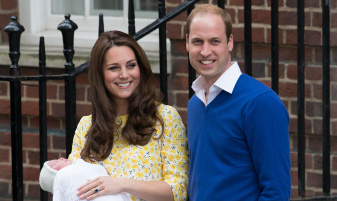 The happy couple and their newborn baby girl pose for the media outside the Lindo Wing of St Mary's Hospital in London.