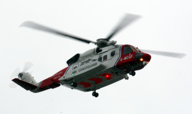 A Coastgurad helicopter involved in the search for a missing plane at Dundee Airport.