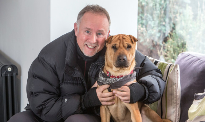 Ian Russell with the dog his rescued dog, Kai, as he backed a campaign called Scottish SPCA Rehoming Week which urges people to adopt a homeless pet.