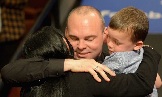 Stuart Bingham celebrates with wife Michelle and son Shae.