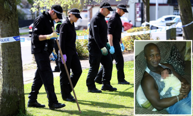 Police search the area of the incident that resulted in the death of Sheku Bayoh (inset).