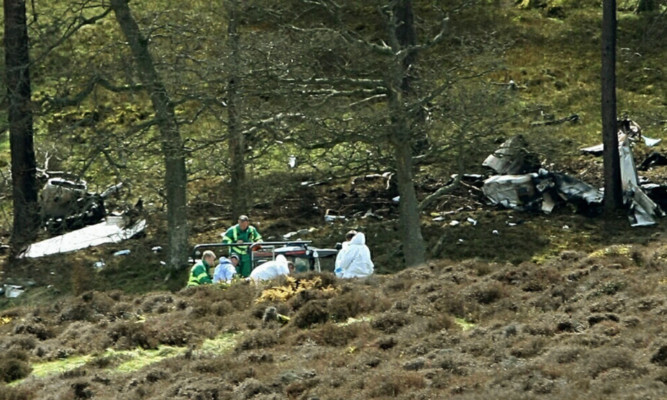 Investigators at the scene of the crash.