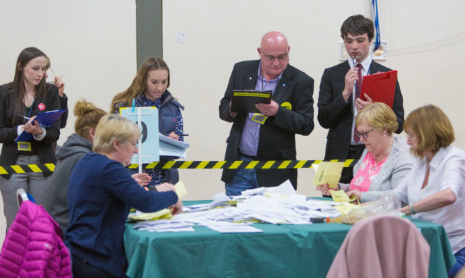 Counting for the Dunfermline & West Fife constituency takes place under the stare of party members.