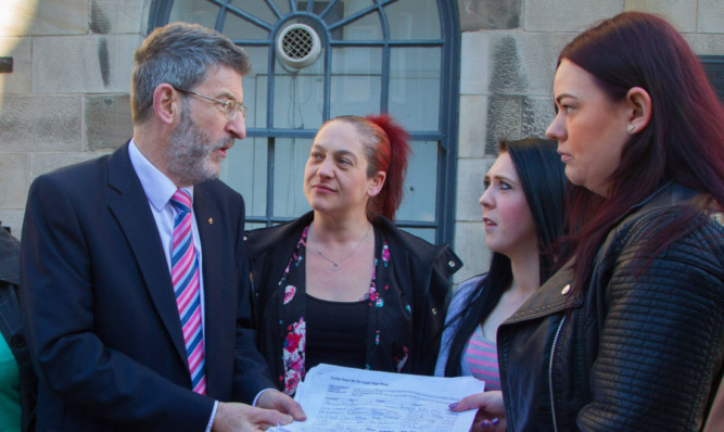 Nigel Don receiving the petition from campaigners Nikki Leasley, Adele Douglas Speirs and Bobbi Murray.