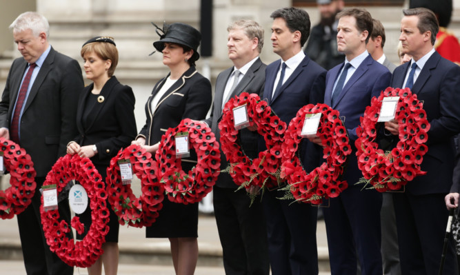 Prime Minister David Cameron (right) stands with Liberal Democrat leader Nick Clegg (second right), Labour leader Ed Miliband (third right) and SNP leader Nicola Sturgeon (second left), as they wait to lay wreaths during a Service of Remembrance to mark the 70th anniversary of VE Day, at the Cenotaph, in Whitehall.