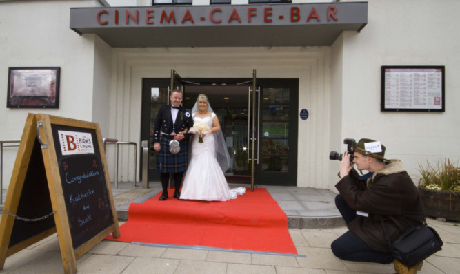 Katherine Dodds and Scott Rix were married at the Birks Cinema. Right: Anthony Smith, kitchen assistant at the Birks Cinema, pretending to be paparazzi.