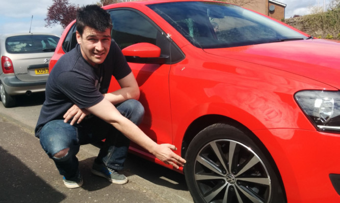 Greg Millar with his girlfriend Gemma Falconers damaged Volkswagen Polo.