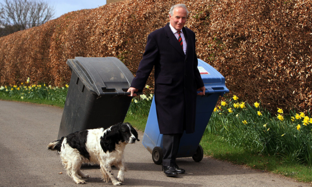 Long haul: Mr Crombie takes his bins to the road.