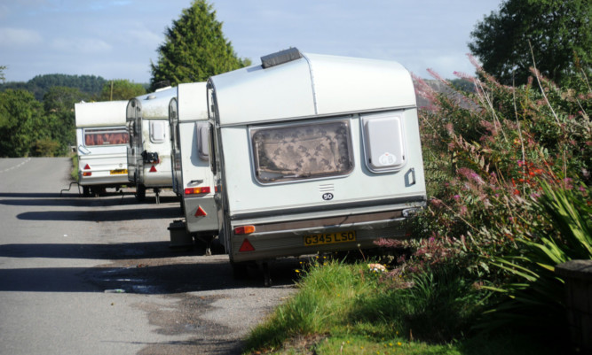 A charged issue: vehicles at the entrance to the Travellers site at Balmuir Woods, Tealing.