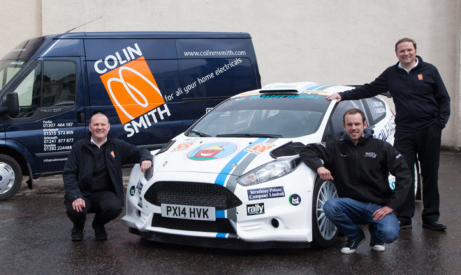 Roland Smith (left) and Jonathen Smith (right) with rally driver John MacCrone.