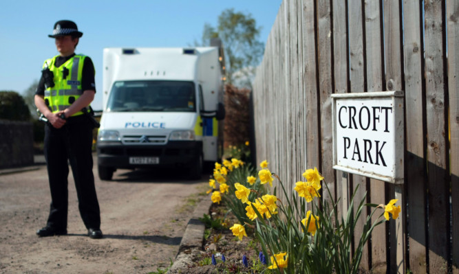 Police guarded the scene at Croft Park, Balbeggie, where Alan Gardner was found dead.