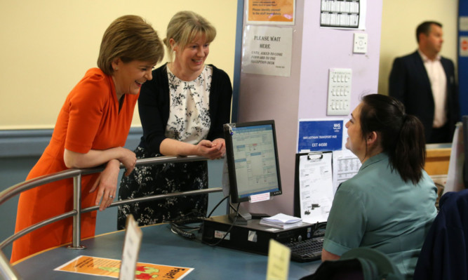 Nicola Sturgeon (left) and Cabinet Secretary for Health Shona Robison talk to a member of staff during a visit to Edinburgh Royal Infirmary, where the First Minister praised staff as A&E performance figures improved to their best level since weekly figures were first published