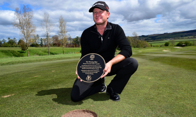 Jamie Donaldson about to lay the plaque marking where he hit the winning shot in the 2014 Ryder Cup at Gleneagles.