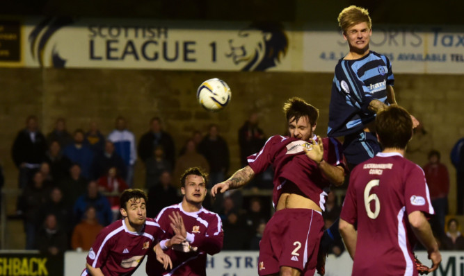 Michael Travis jumps high to grab what could be an all-important third goal for Forfar.