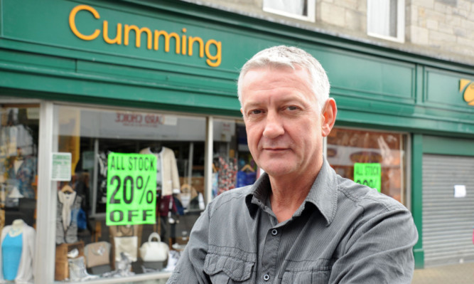 Councillor Tom Adams outside the store.