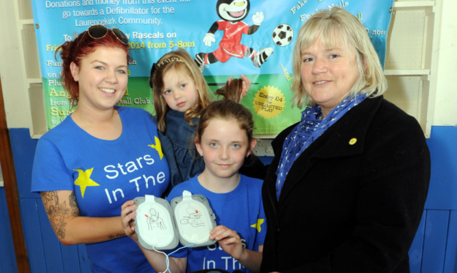 Megan Mitchell with Amys children Halle, left, and Chloe Reid and Claire Maitland, co-founder of the Sandpiper Trust, right.